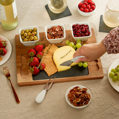 ELEGANT SLATE CHEESE BOARD - Enhance your hors d'oeuvres presentation with this acacia wood and slate cheese board set. Designed with removable ceramic bowls, 2 cheese tools, and a slate cheese tray, it brings extra class to your entertaining.