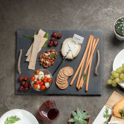 ELEGANT SLATE CHEESE BOARD - Upgrade your hors d'oeuvres presentation with this handled slate cheese board and chalk set. Designed with a velvet backing to protect table surfaces, this appetizer service set brings extra class to your entertaining.