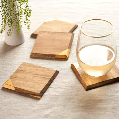 UNIQUE DECOR WOODEN DRINK COASTERS - Add a modern look to your house or bar with these smooth square wood coasters for drinks. These coasters for coffee tables have finely sanded corners and a bright copper accent that makes them stand out.