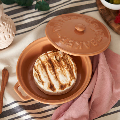 CERAMIC BRIE BAKING DISH - Everybody loves baked brie cheese bites. This tried and true appetizer just got easier with our ceramic bakeware set. Complete with a lid, handles, and an acacia wood spreader for serving, this brie baker is useful and beautiful.