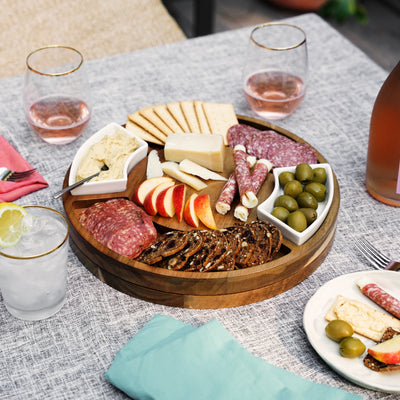 LAZY SUSAN SERVING BOARD - Serve cheese in style with a round charcuterie board. This rotating cheese board includes separate compartments for cheese, cured meat, or olives. Guests can spin the wooden cheese board to reach their favorites.