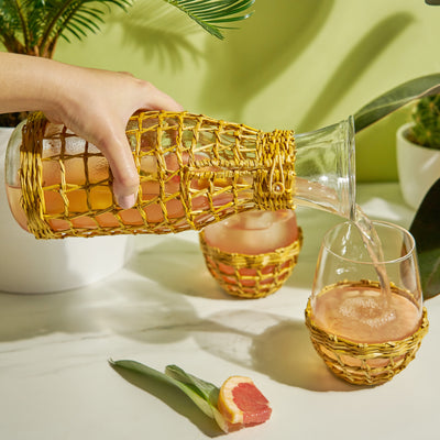 UNIQUE NETTED GLASSWARE - Bring carefree coastal charm to your glassware. Clear glass wrapped in seagrass weaving recalls fisherman floats, tiki cocktails, and the slow pace of island life—perfect for a small cabin on a bluff or a modern beachy home.
