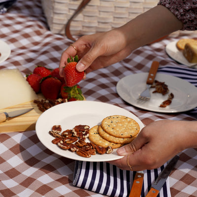 COMPLETE FOUR PERSON PICNIC BASKET SET: This outdoor picnic basket with accessories has everything you need for a picnic basket for 4 friends. Complete with 4 sets of plates, silverware, wine glasses, and cloth napkins, this white picnic basket elevates your beach day or lake party.