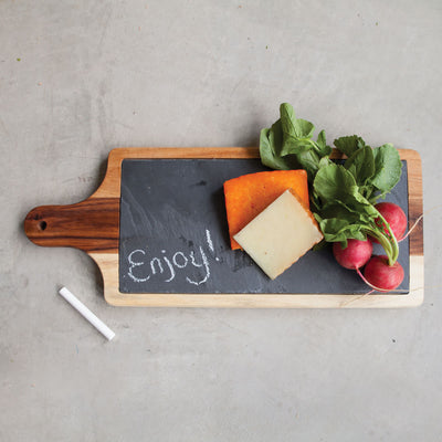 ELEGANT ACACIA WOOD CHEESE BOARD - Upgrade your hors d'oeuvres presentation with this acacia wood cheese board. Designed with a classic paddle shape and a slate inset for labeling, this set brings extra class to your entertaining.