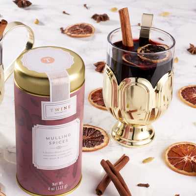 GILDED MULLED WINE GLASS - Perfect for sipping mulled wine, hot toddies, or spiked hot chocolate, this festive glass has a gold-plated stainless steel base and a clear glass vessel that shows off your cocktails. Add a touch of gilding to happy hour.