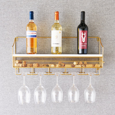 WHITE AND GOLD WALL-MOUNTED WINE RACK  - This sturdy wall-mounted wine rack is an elegant storage solution for your wine collection. Cast iron and wood construction with a gold finish makes this bottle rack stylish and solid while saving counter space.
